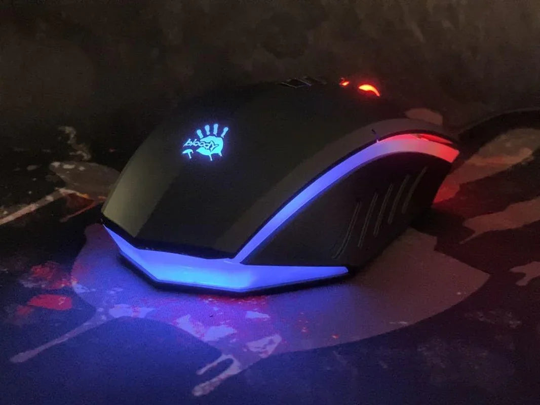 Gaming mouse with blue and red LED lighting on a dark patterned mouse pad