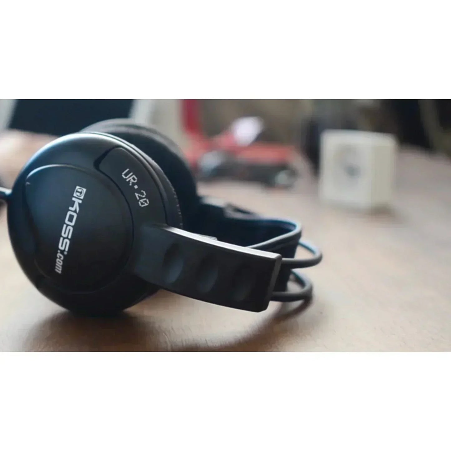 Black Koss UR-20 over-ear gaming headset on a wooden desk