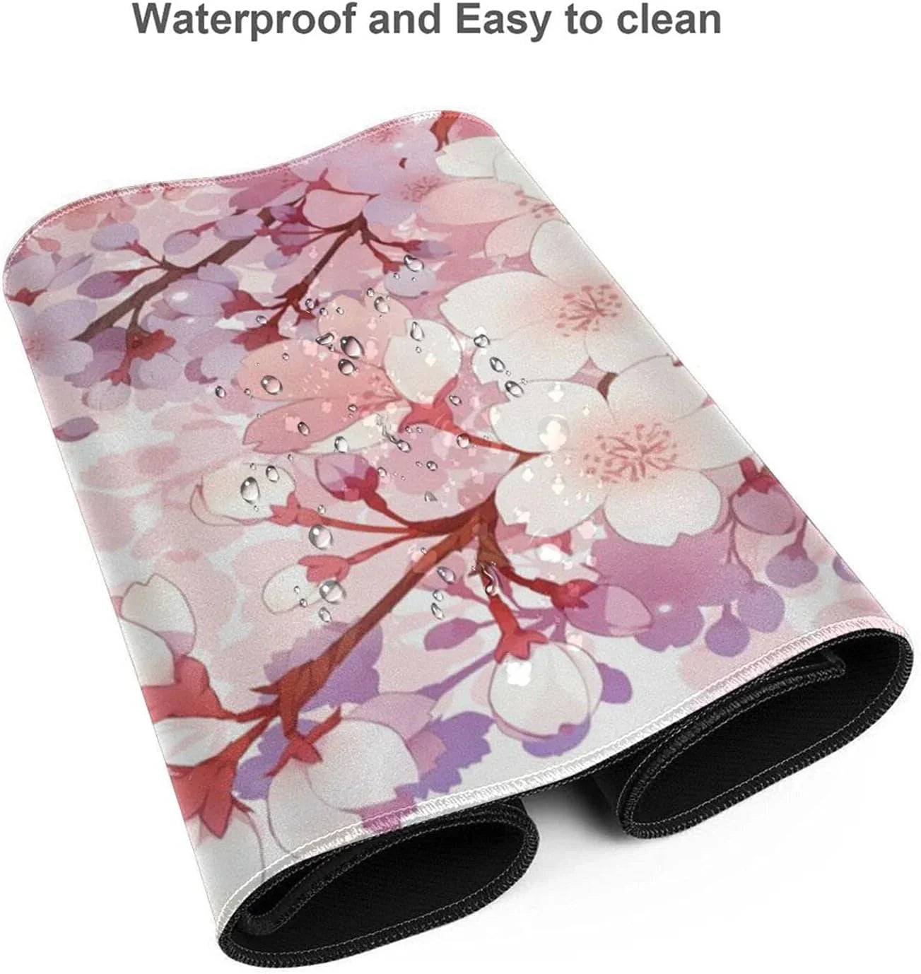 Folded waterproof gaming mouse pad with pink and white cherry blossom design and water droplets