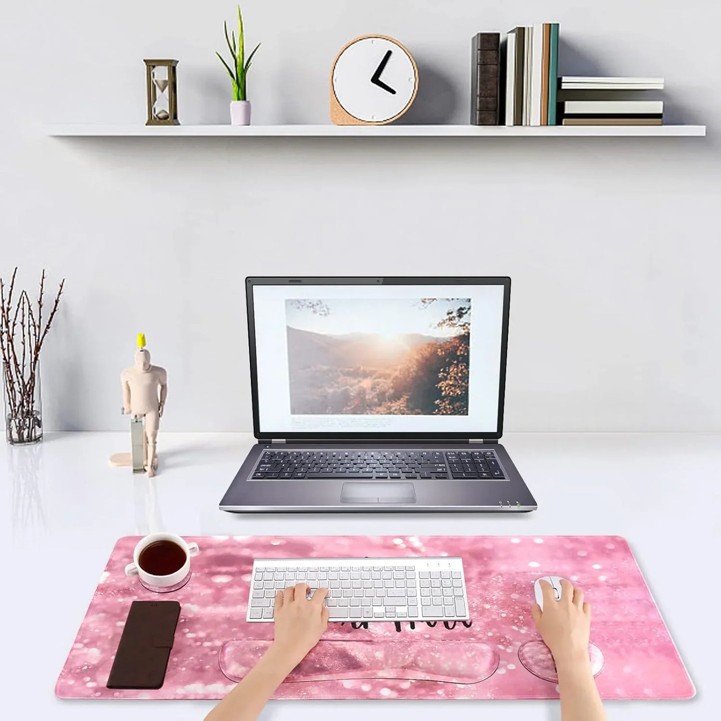 Minimalistic workspace with laptop, white wireless keyboard and mouse on pink custom RGB desk mat