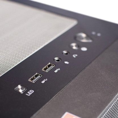 Close-up of a gaming PC case front panel with USB ports, audio jacks, and LED button