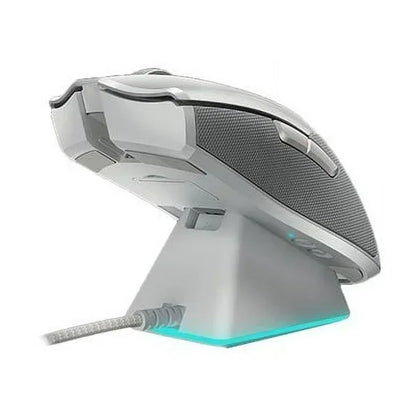 White wired gaming mouse with RGB lighting on a charging dock, side view