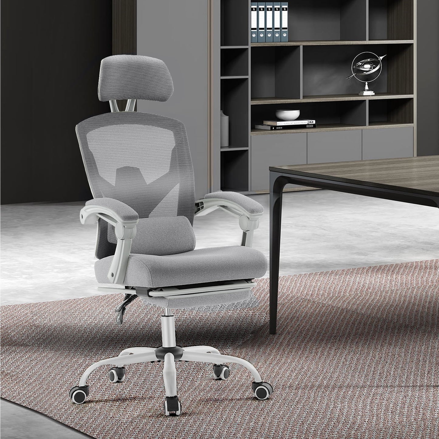 Gray ergonomic office chair with mesh back, headrest, and lumbar support in modern workspace