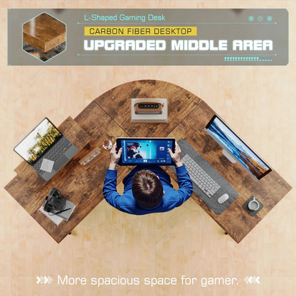 Top view of L-shaped gaming desk with carbon fiber desktop, dual monitors, gaming tablet, and accessories