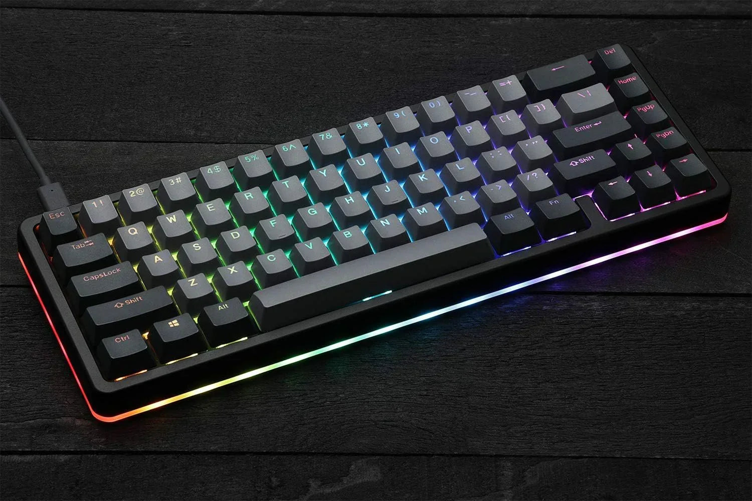 RGB backlit mechanical gaming keyboard on black wooden desk, Byte Style modern setup