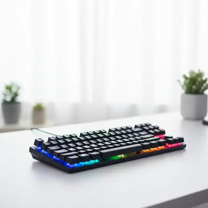 Compact mechanical keyboard with RGB backlighting on white desk with blurred plants in background