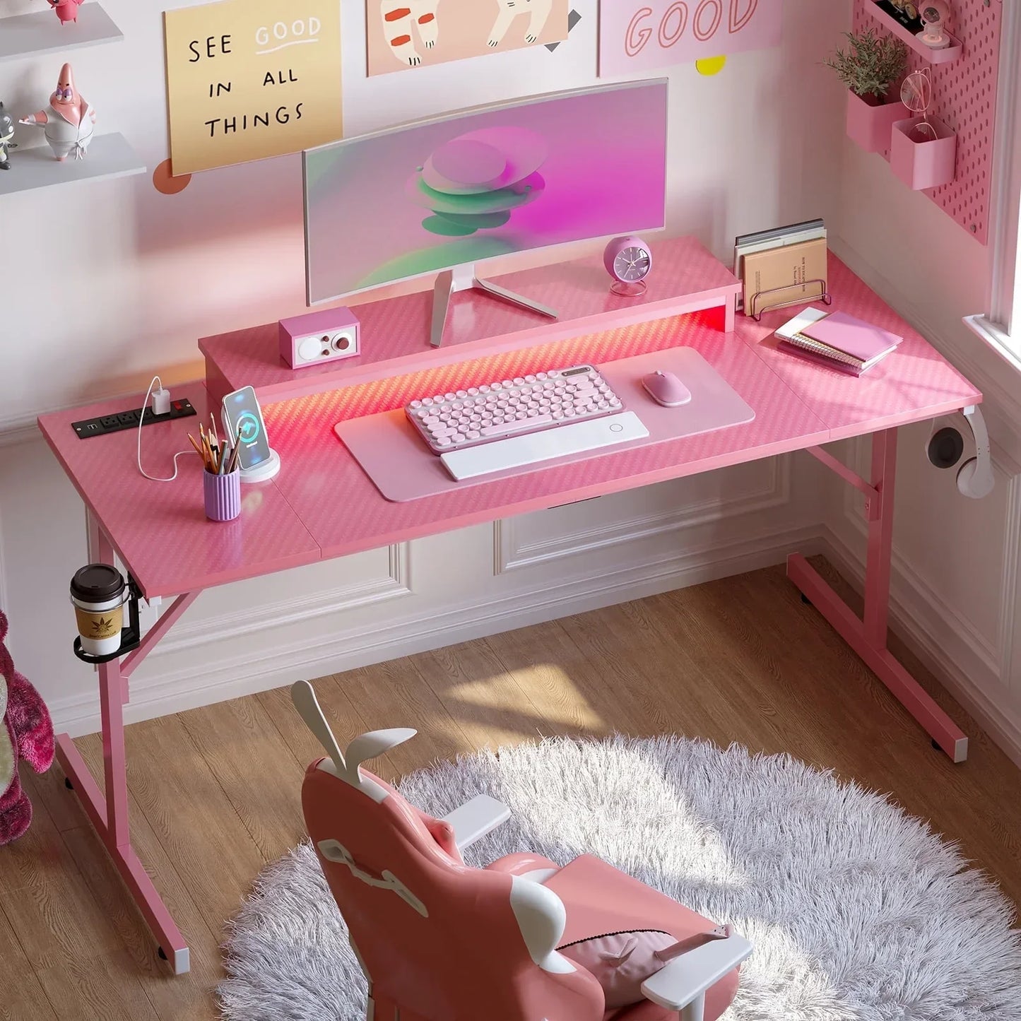 Pink gaming desk setup with curved monitor, mechanical keyboard, mouse, and ergonomic chair on white rug