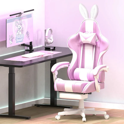 Pink and white gaming chair with bunny ears and pillow next to a desk with pink keyboard, mouse, and monitor