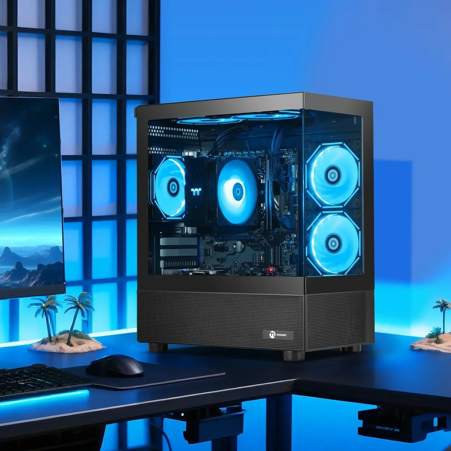Gaming PC with RGB fans on desk, blue LED lighting, monitor and mouse in modern setup