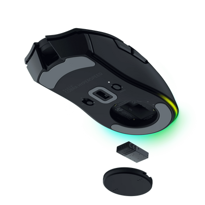 Bottom view of black Razer Cobra Hyperspeed gaming mouse with USB dongle and battery removed, glowing green light