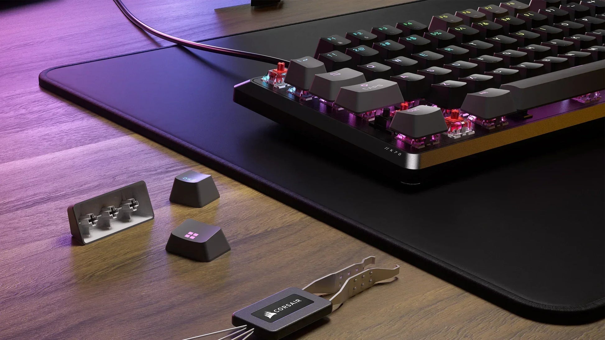 RGB mechanical gaming keyboard on mousepad with removed keycaps and Corsair keycap puller on desk