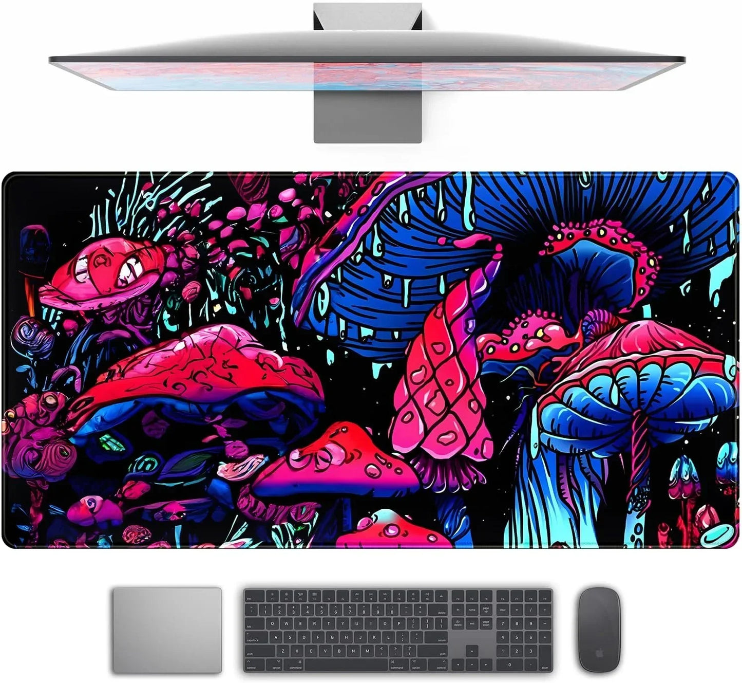 Brightly colored gaming desk mat with neon pink and blue psychedelic mushroom design beneath monitor, keyboard, and mouse