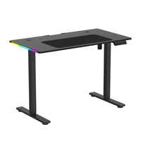 Black adjustable standing desk with RGB LED lighting strip and digital control panel for height settings