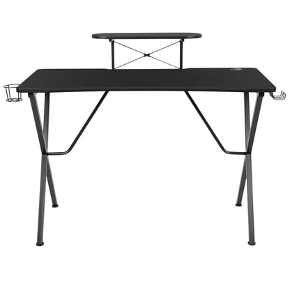 Black modern gaming desk with elevated monitor shelf, cup holder, and headphone hook