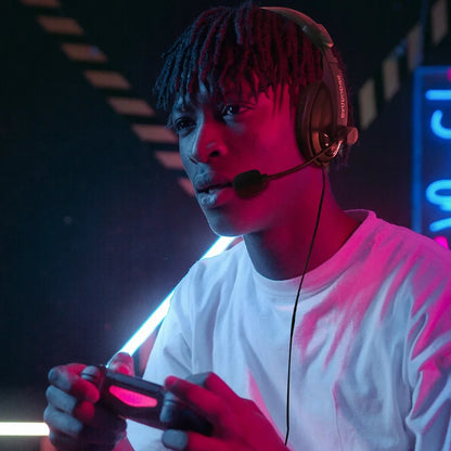 Gamer wearing headset and white shirt intensely playing video games with controller in neon-lit room
