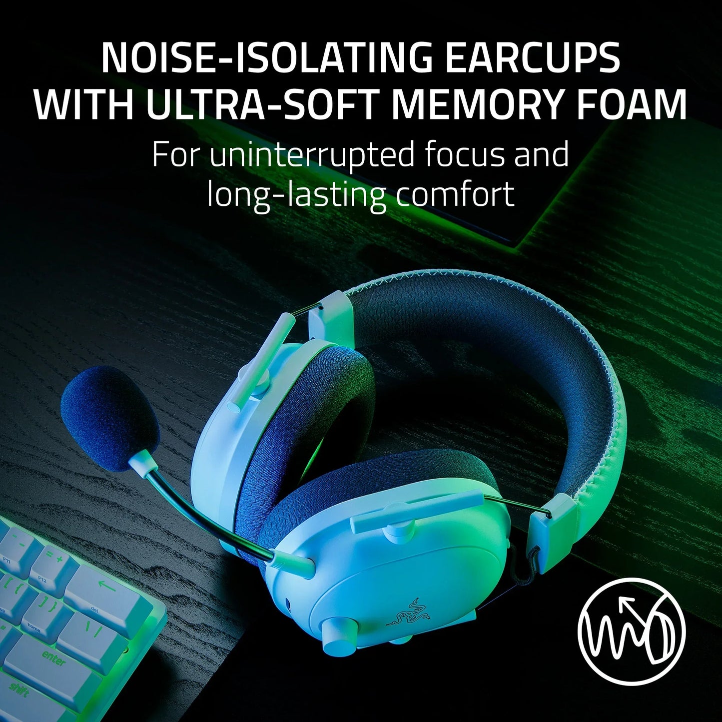 White Razer gaming headset with noise-isolating earcups and ultra-soft memory foam on black desk near keyboard