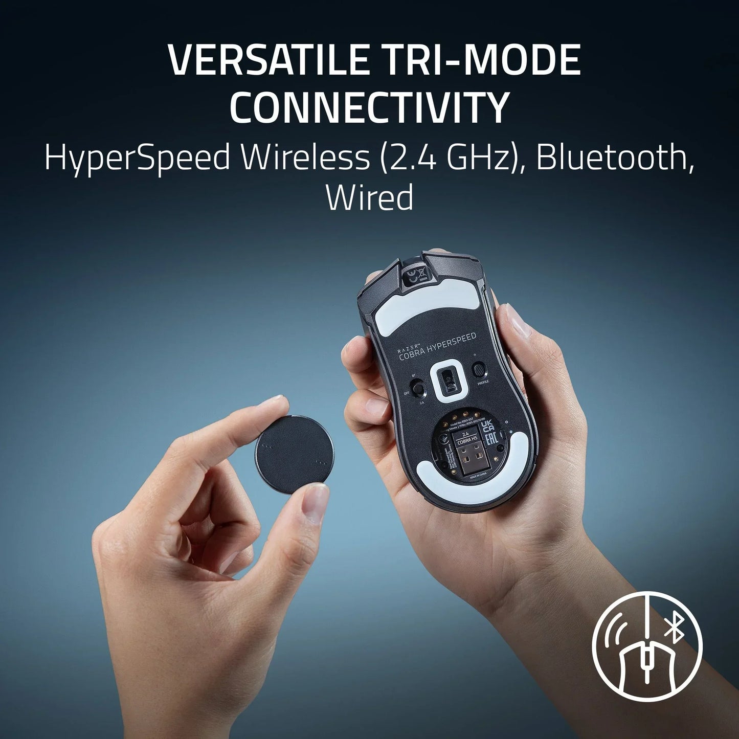 Hand holding Razer Cobra Hyperspeed gaming mouse showing tri-mode wireless, Bluetooth, and wired connectivity