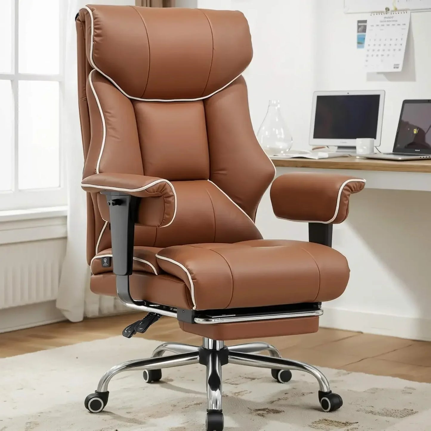 Brown leather gaming office chair with white stitching, adjustable arms, and chrome base in home setup