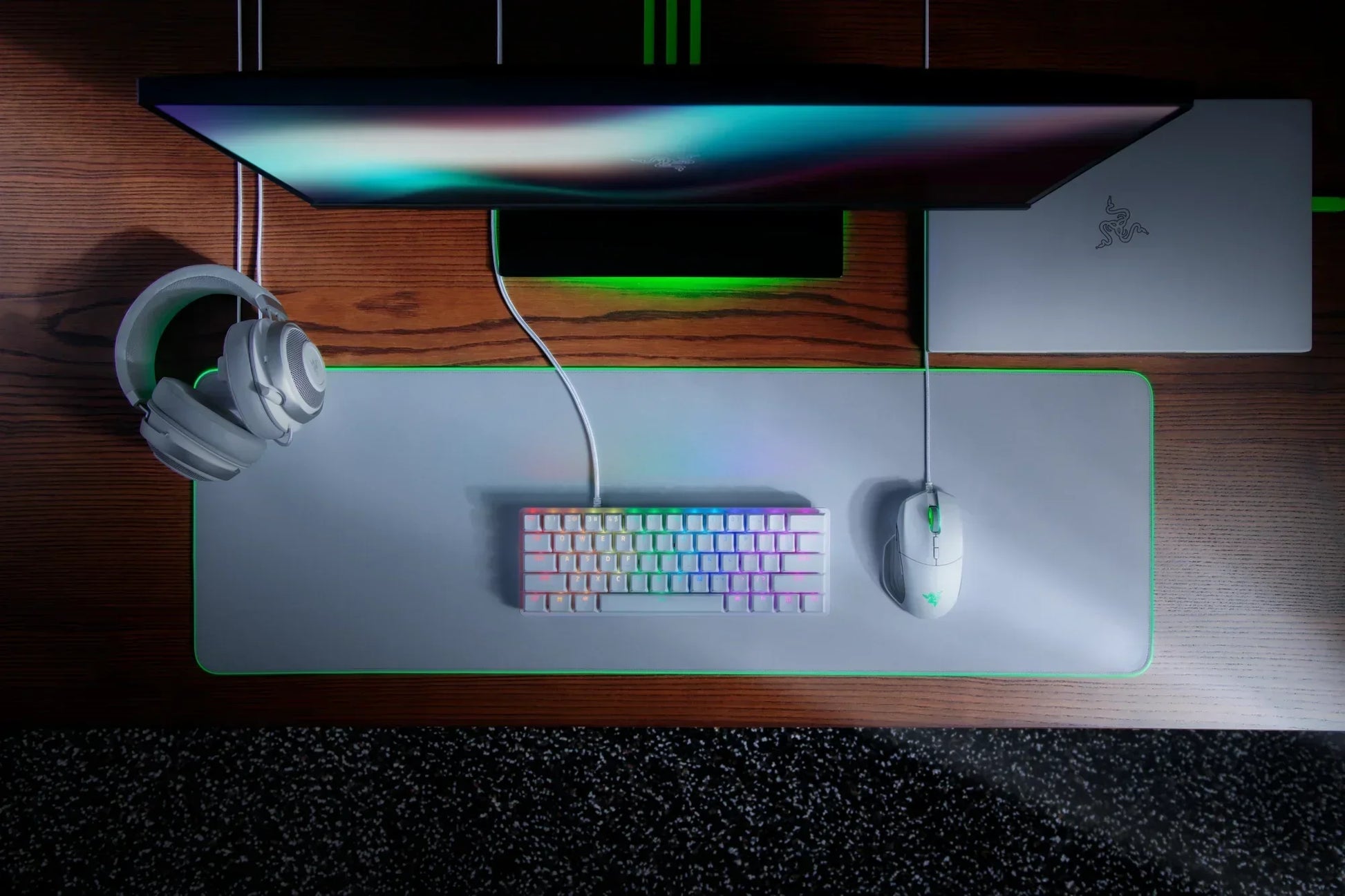 RGB gaming keyboard, headset, and mouse on desk setup with monitor and laptop, Byte Style