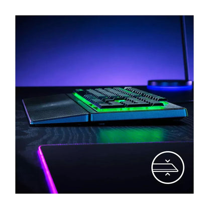 RGB-backlit gaming keyboard with wrist rest on a dark desk, retro 8-bit style setup