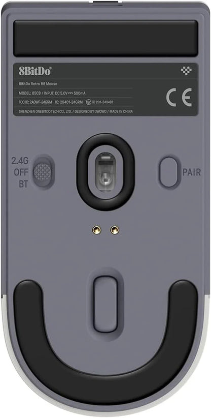 Bottom view of retro 8BitDo wireless gaming mouse with sensor, switches, and rubber grips