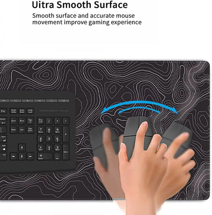 Gaming mouse on ultra smooth surface mousepad with topographic pattern next to black keyboard