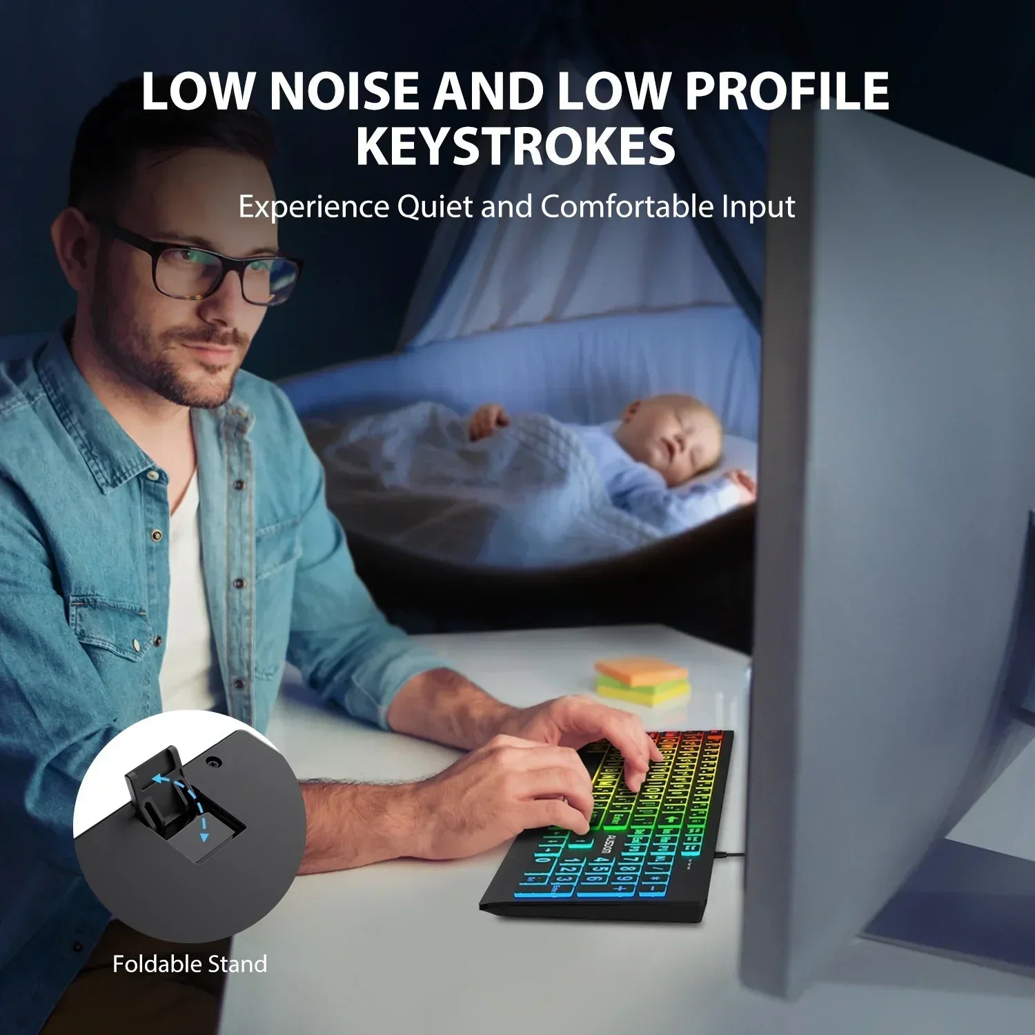 Man using RGB gaming keyboard at desk near sleeping baby, promoting quiet, low-profile keystrokes