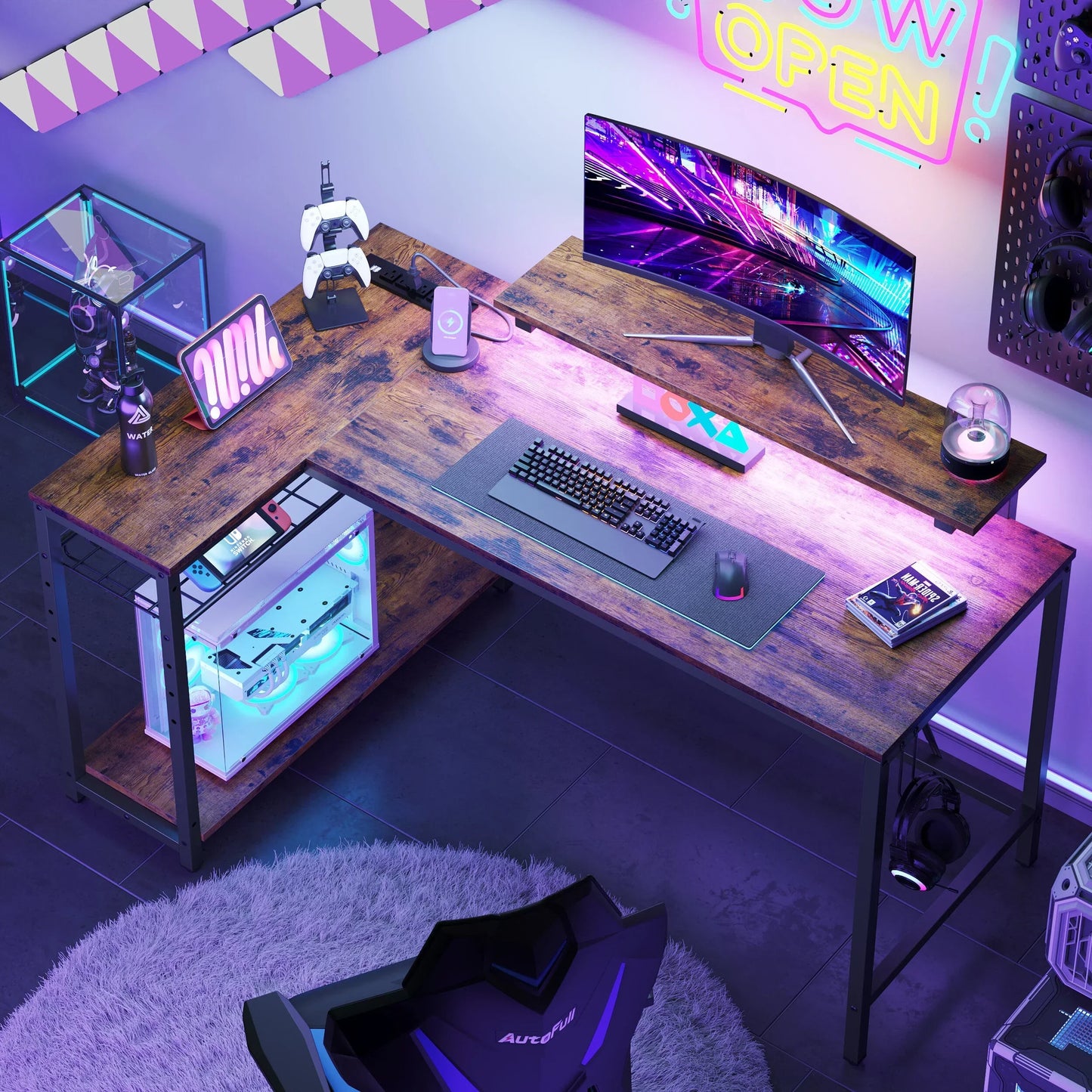Modern gaming setup with curved monitor, mechanical keyboard, PC, game controllers, and neon lighting