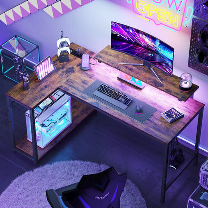 Modern gaming setup with curved monitor, mechanical keyboard, PC, game controllers, and neon lighting