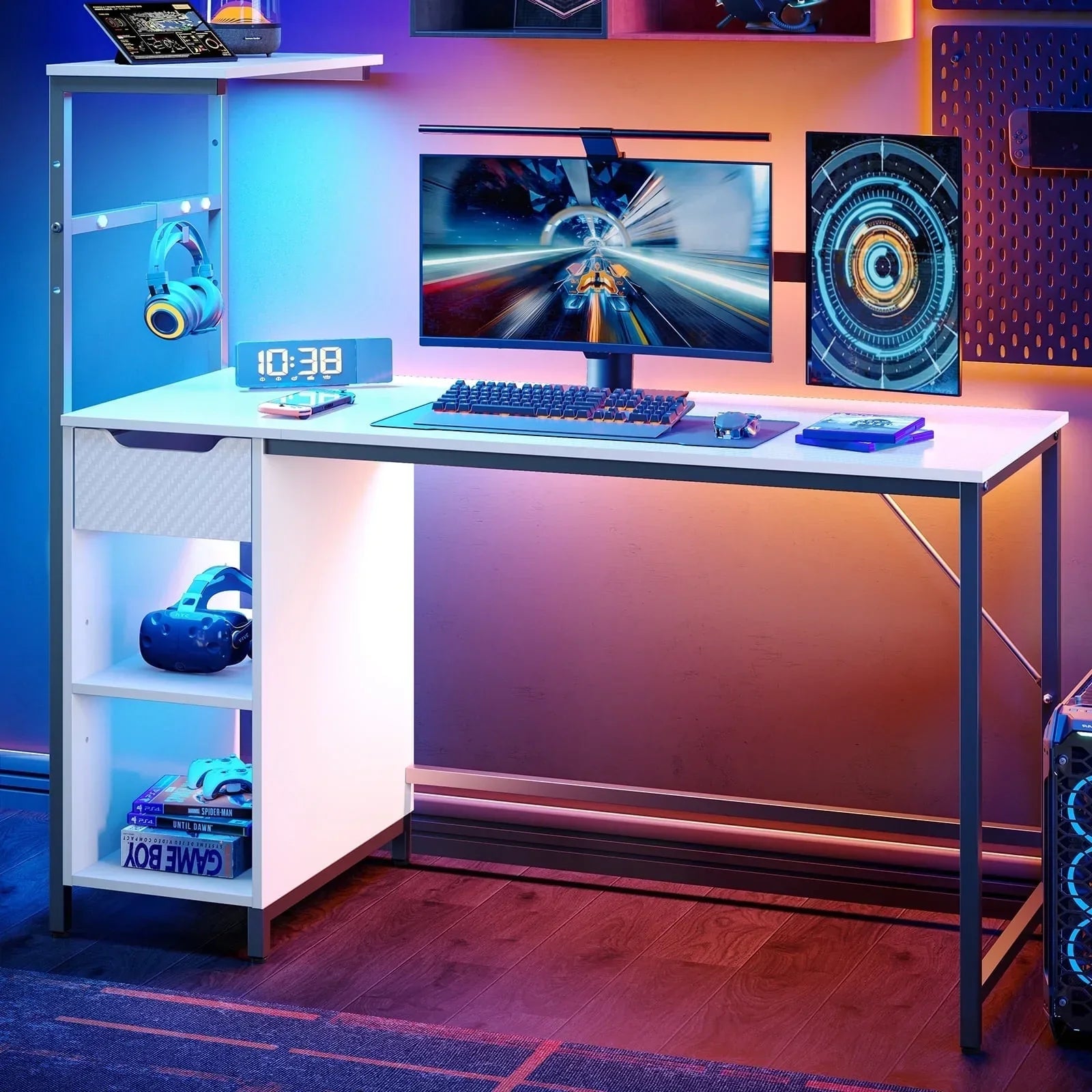 Modern white gaming desk setup with curved monitor, RGB backlighting, VR headset, headphones, keyboard, and game boxes