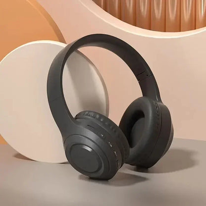 Wireless over-ear gaming headphones in matte black on geometric beige background