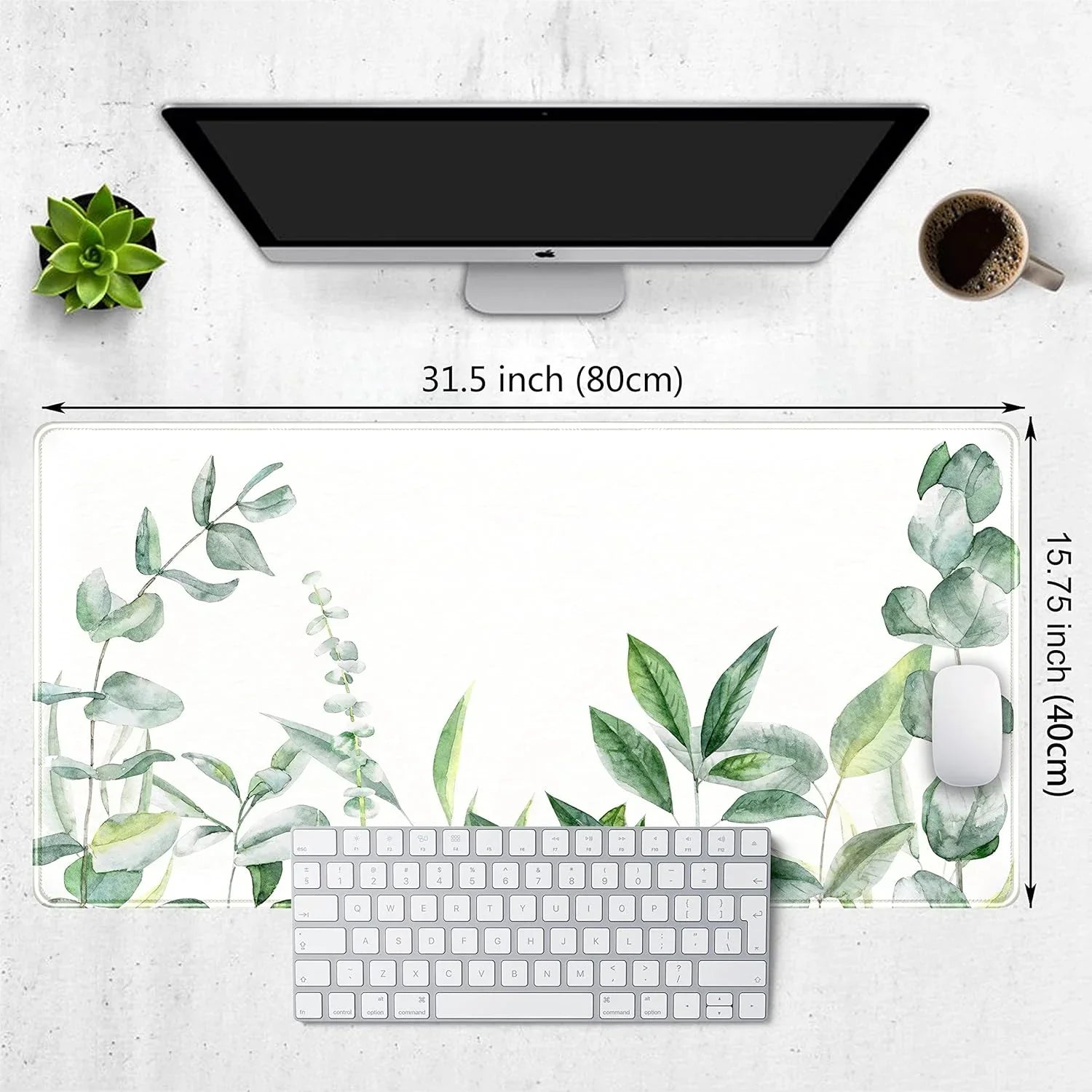 Desk setup with a 31.5x15.75 inch white mousepad featuring green watercolor leaves, an Apple keyboard and mouse, succulent plant, and coffee cup