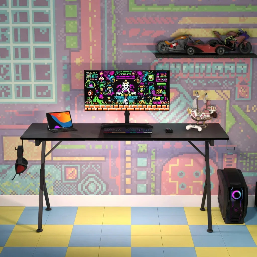 Retro gaming desk setup with 8-bit wallpaper, PC, monitor, keyboard, and accessories