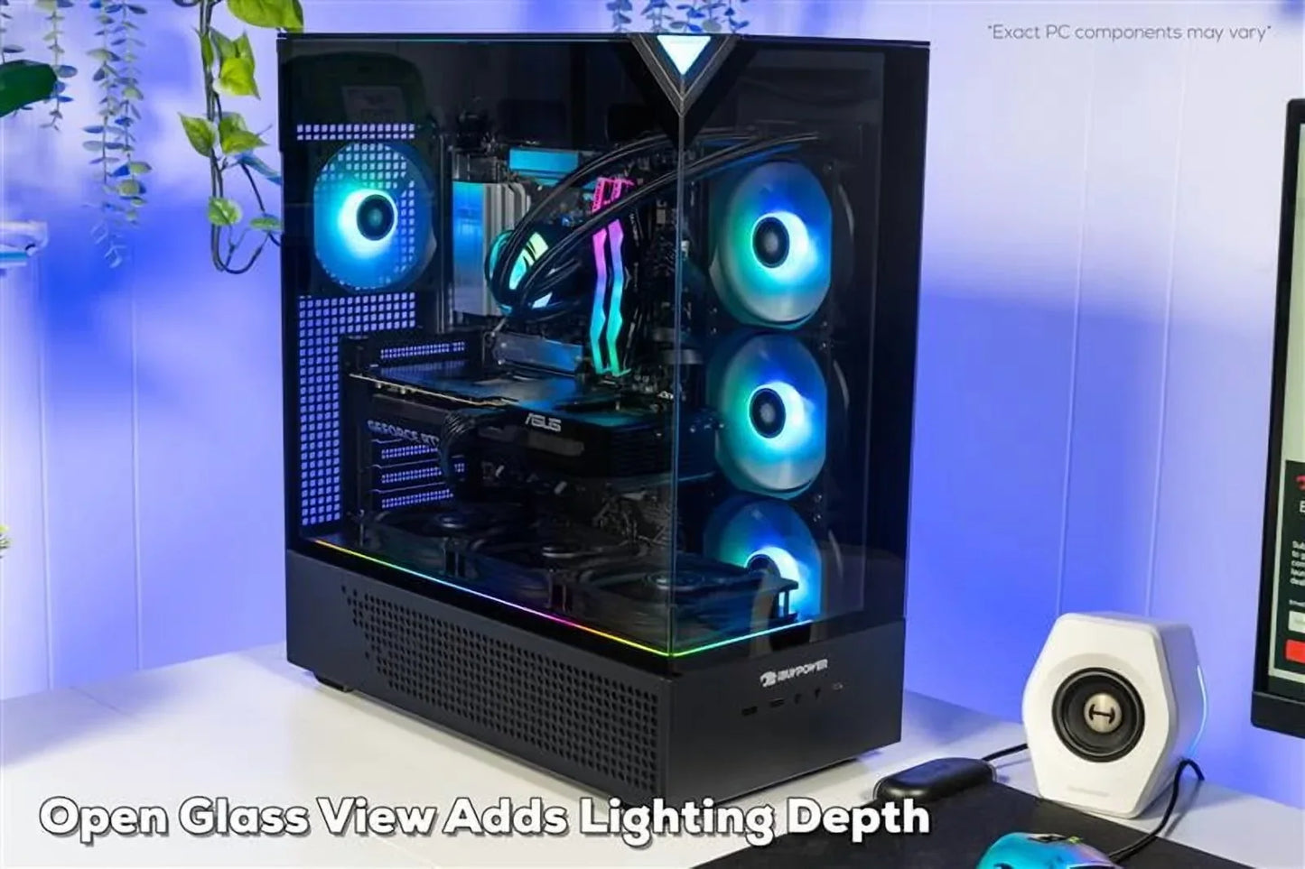 Gaming PC with transparent glass case and blue LED fans on a white desk, next to a white speaker and mouse