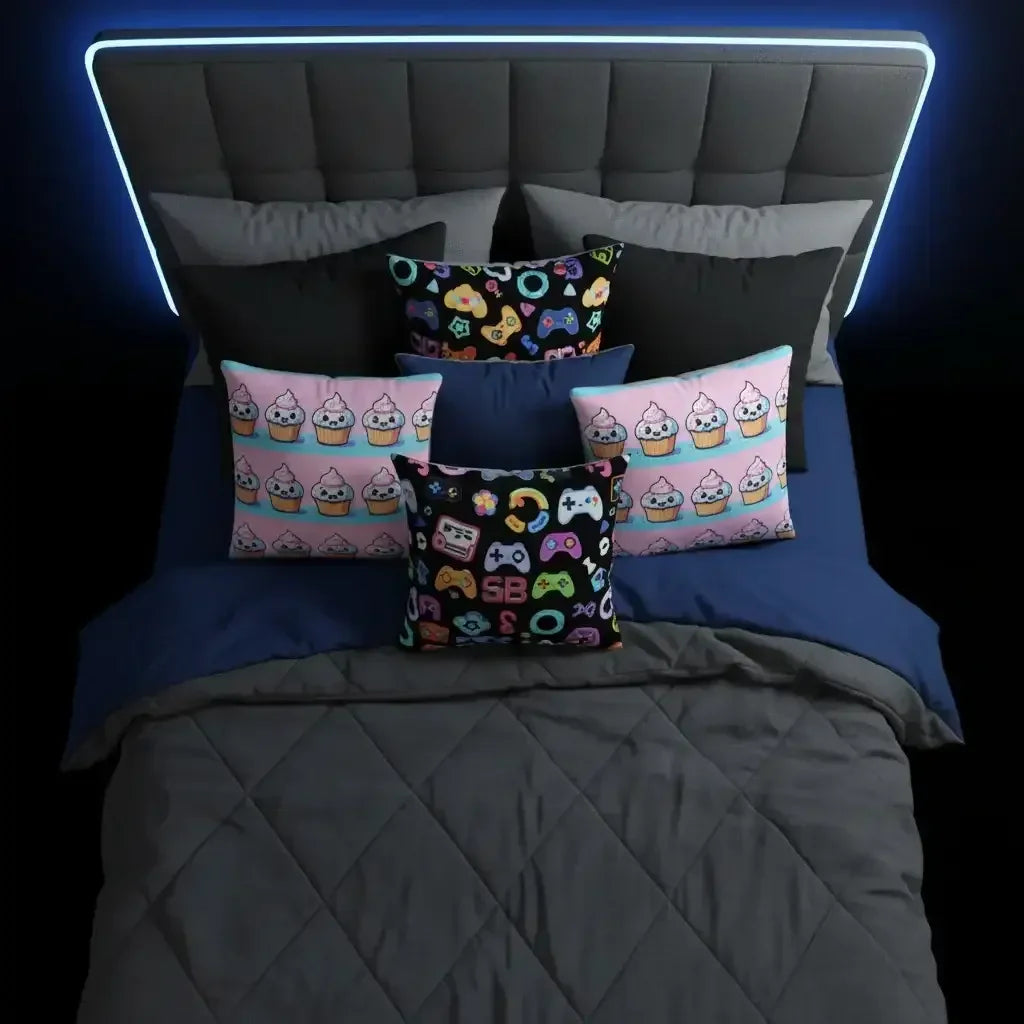 Modern bed with colorful gamer and cupcake pillows, blue quilt, and LED headboard.