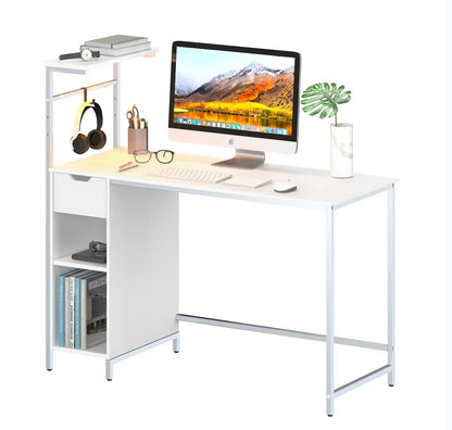 Modern white office desk with iMac, wireless keyboard and mouse, books, glasses, headphones, and plant
