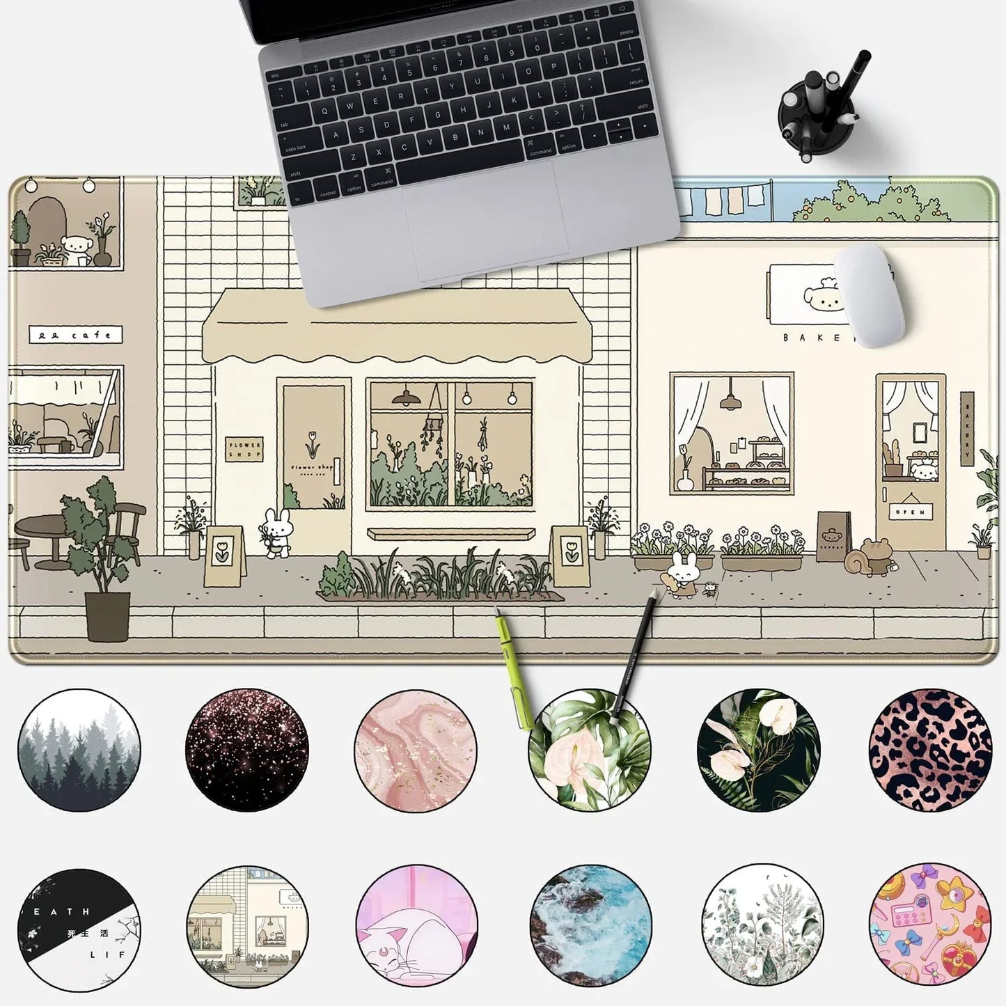 Large mouse pad featuring cute hand-drawn street scene with flower shop and bakery, laptop and mouse on top