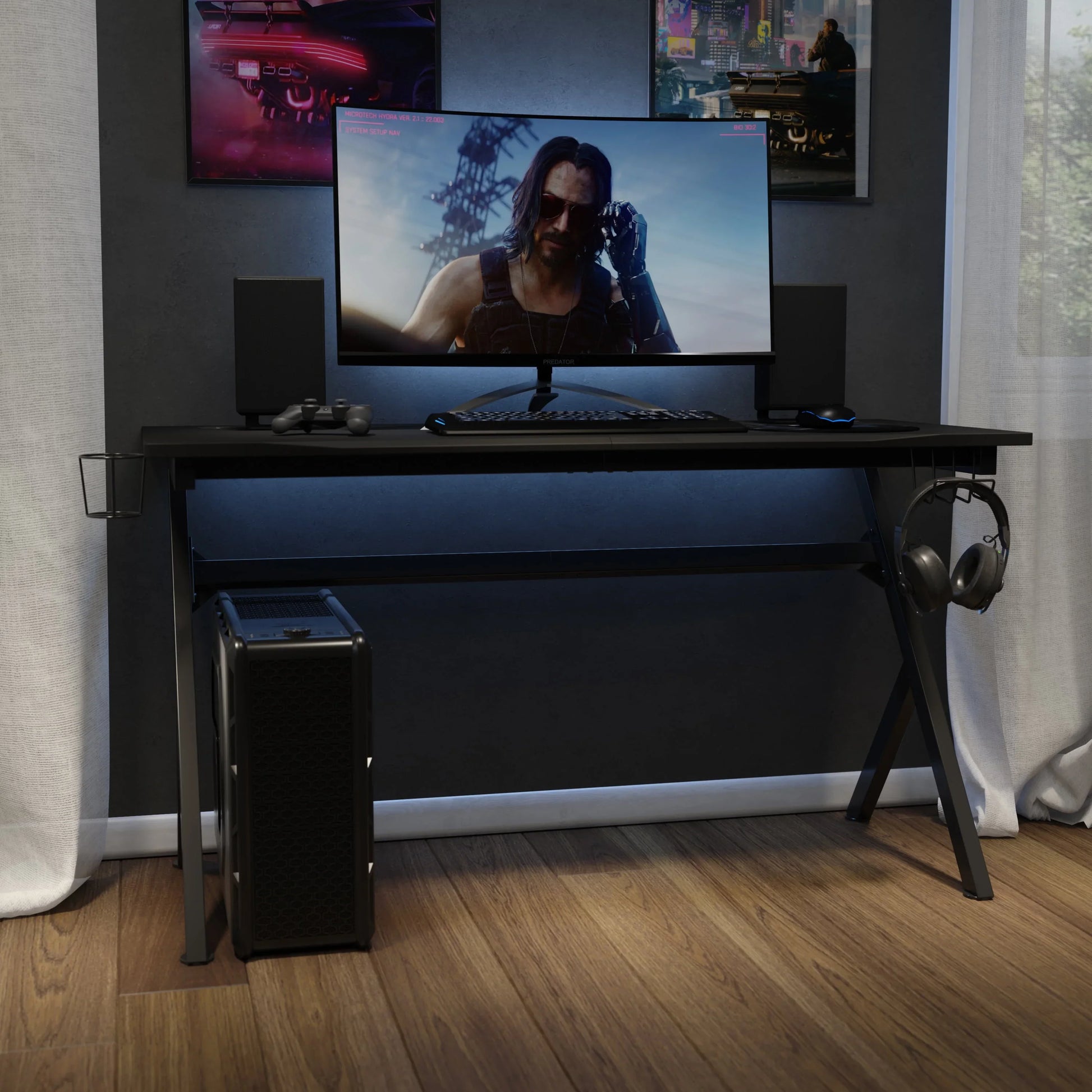 Modern black gaming desk setup with ultrawide monitor showing cyberpunk character, keyboard, mouse, speakers, and PC tower