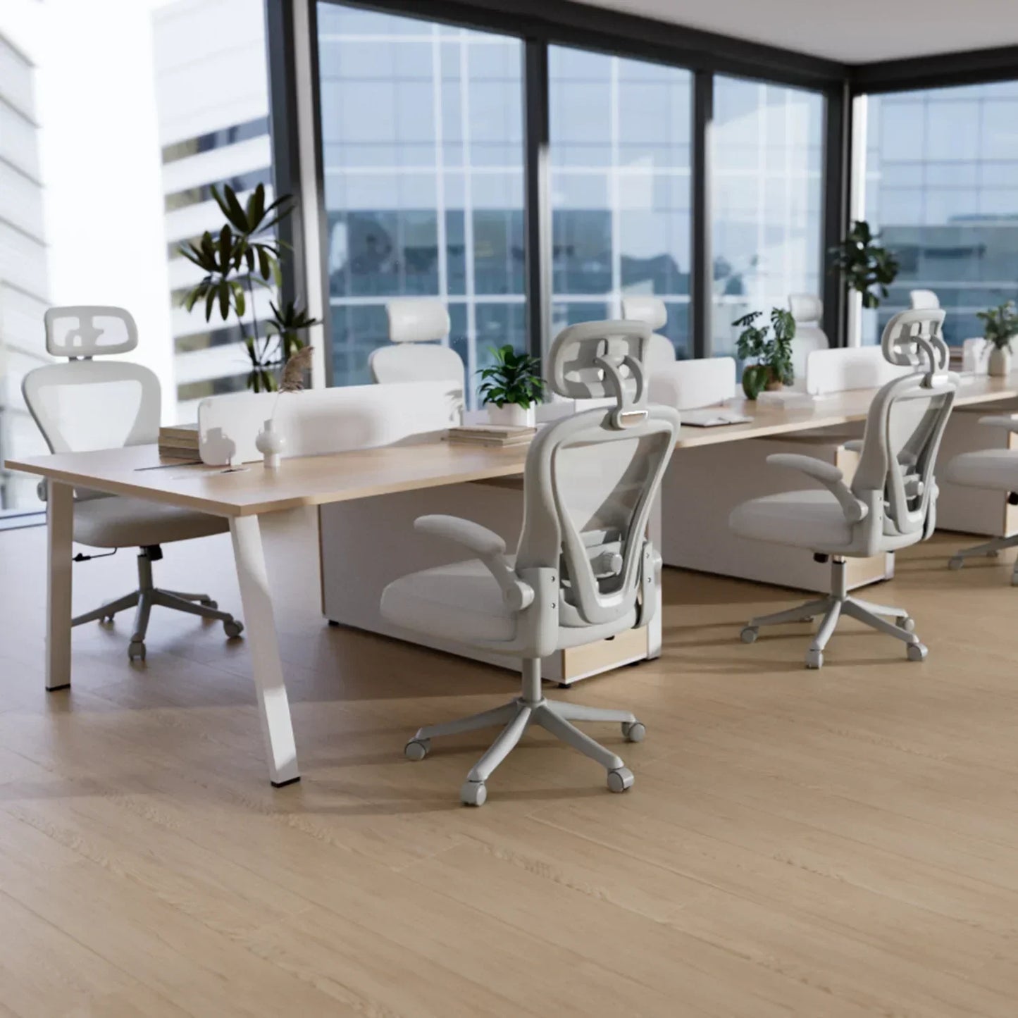 Modern ergonomic office chairs at sleek desks in bright, minimalist workspace with large windows