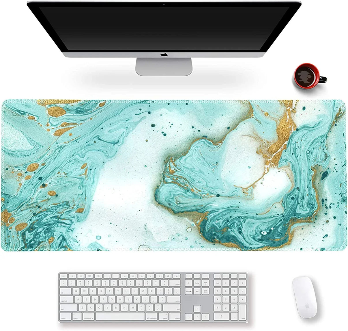 Modern desk setup with Apple computer, keyboard, mouse, teal and gold marble gaming desk mat, and red coffee cup