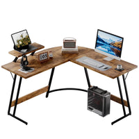 Modern L-shaped wooden computer desk with black metal legs, desktop monitor, keyboard, tablet, and accessories