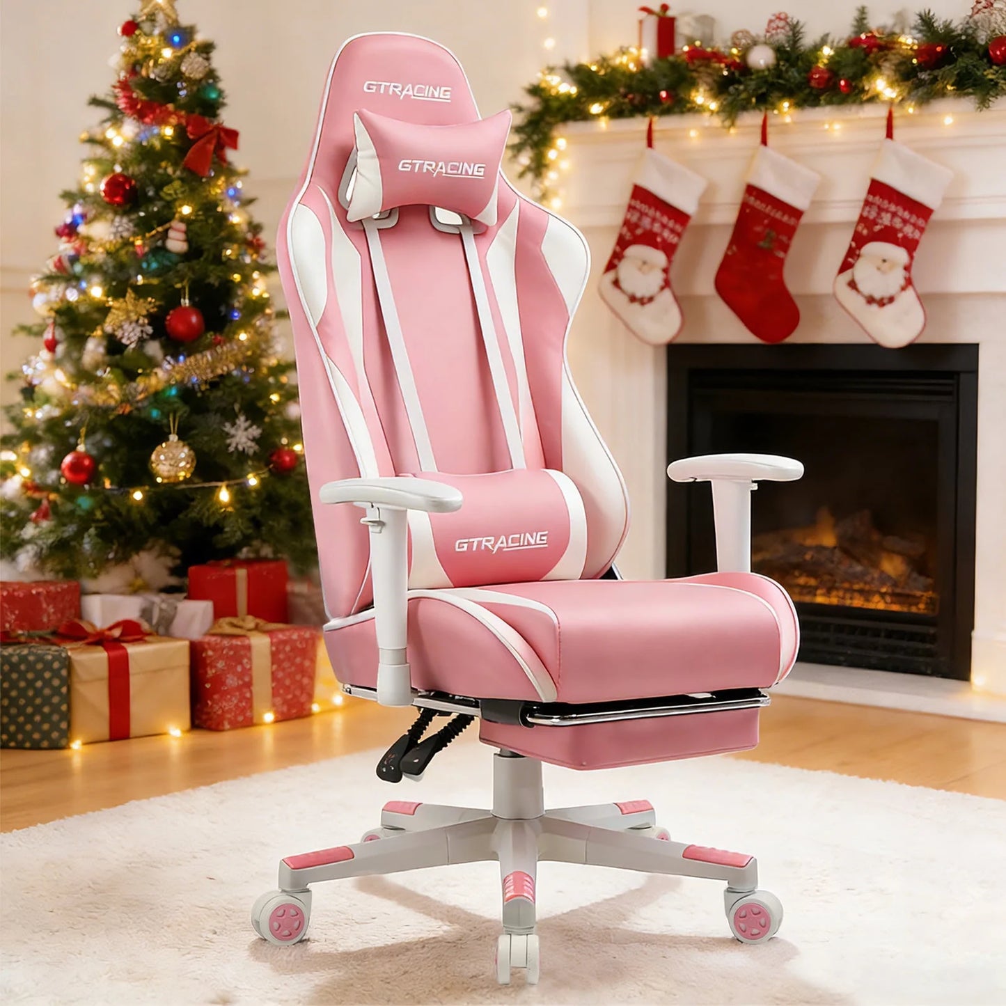Pink GTRACING gaming chair with white accents, set in a festive Christmas room with tree and stockings.