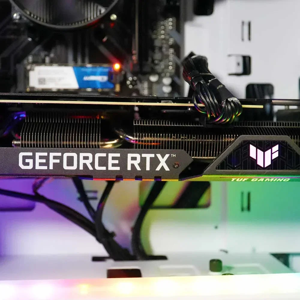 Close-up of ASUS TUF Gaming GeForce RTX graphics card inside a gaming PC with RGB lighting