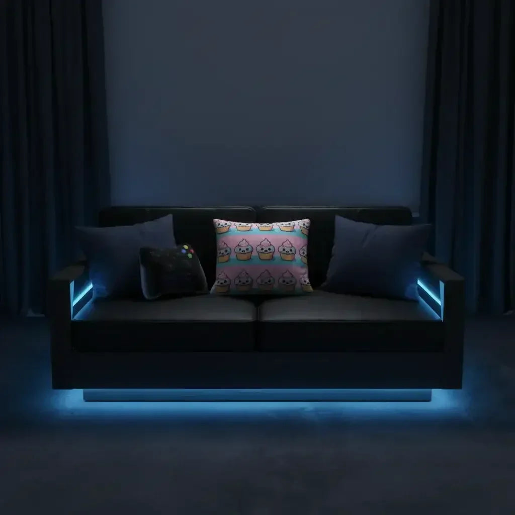 Modern black sofa with LED blue lighting, cupcake pillow and gaming decor in a dark room