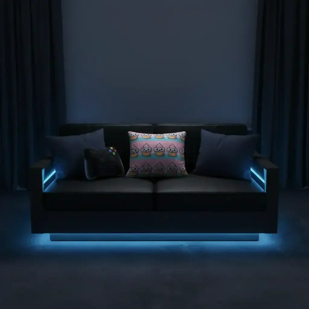 Black modern sofa with three decorative pillows and blue LED accent lighting in a dark room
