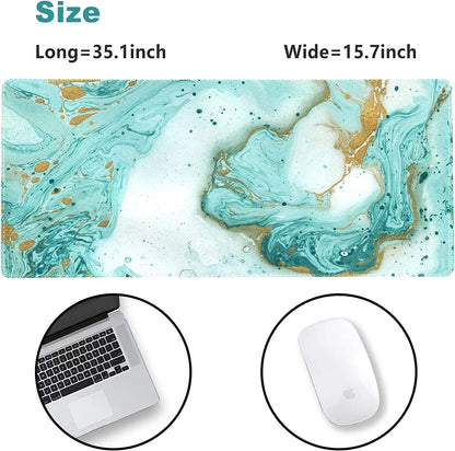 Large desk mouse pad with marble pattern in teal and gold, sized 35.1 by 15.7 inches, shown with laptop and white mouse