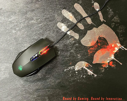 Black RGB gaming mouse with cord on black mouse pad featuring red and gray handprint graphic