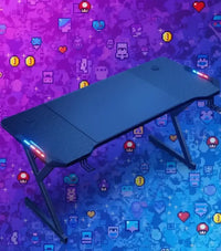 Modern black gaming desk with LED lights against a colorful pixel art background