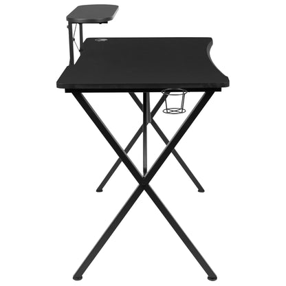Black gaming desk with X-shaped metal legs, raised side shelf, and cup holder against white background