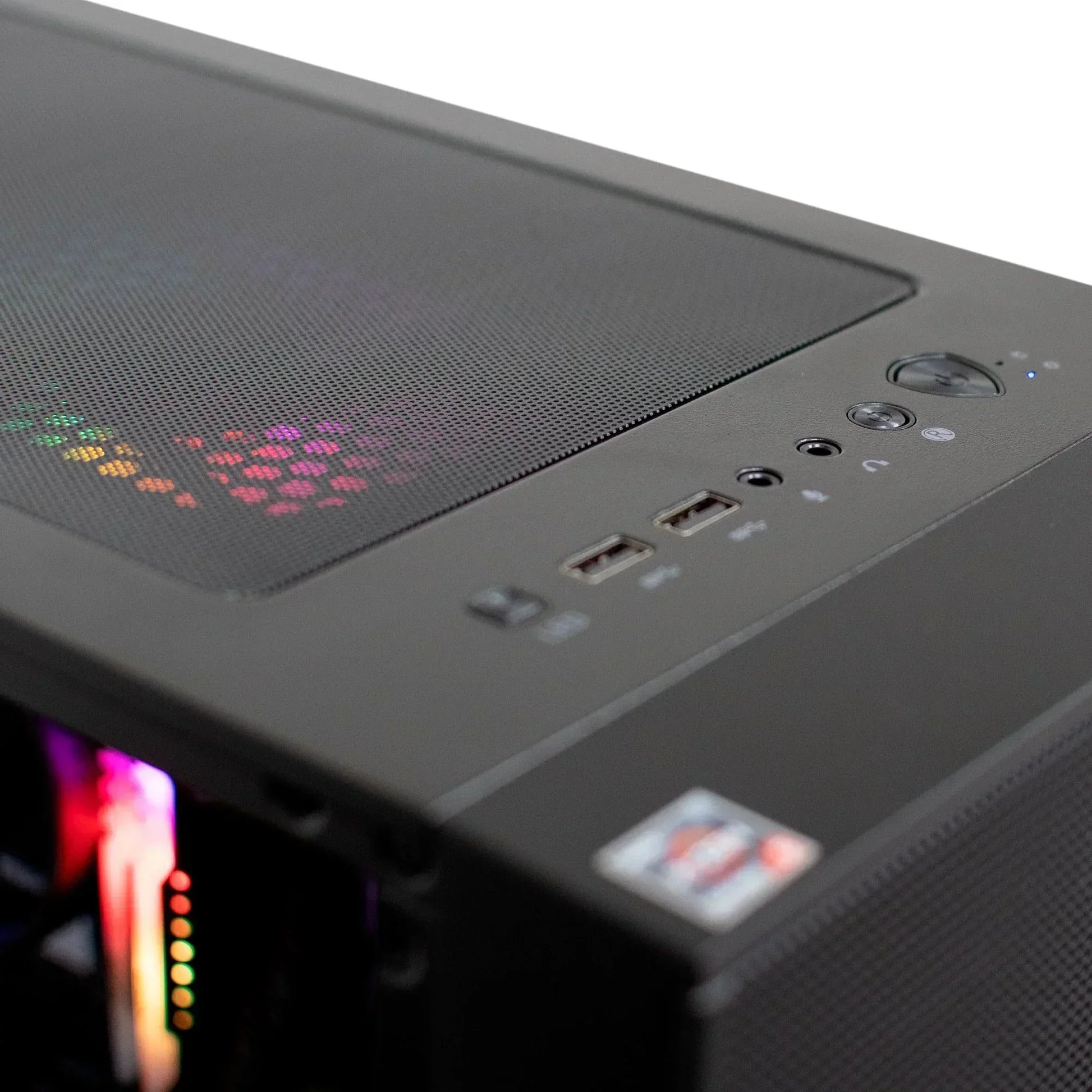 Close-up of black gaming PC case top with RGB fan, USB ports, and power button